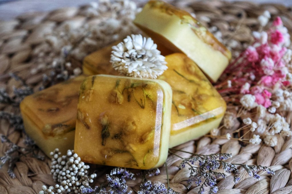 Yellow botanical herb soap bars with dried flowers product photography