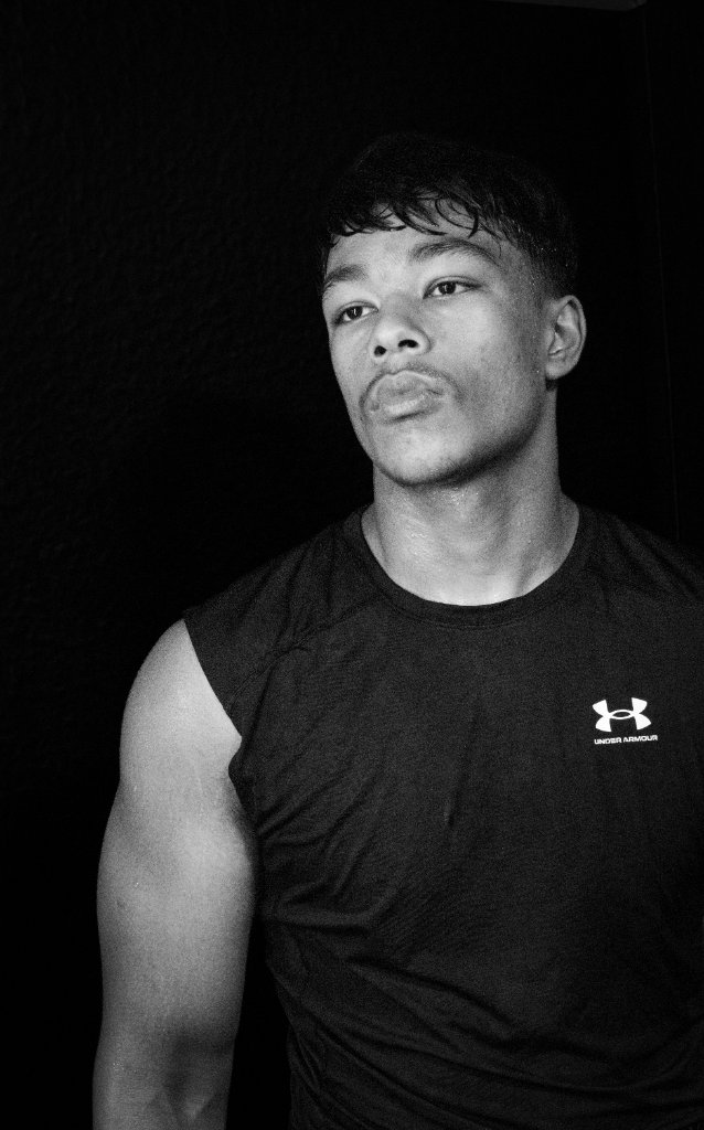 Black and white portrait of boxer in profile with dramatic studio lighting