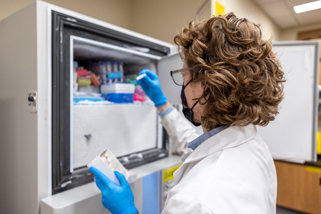 Scientist retrieving samples from a laboratory freezer