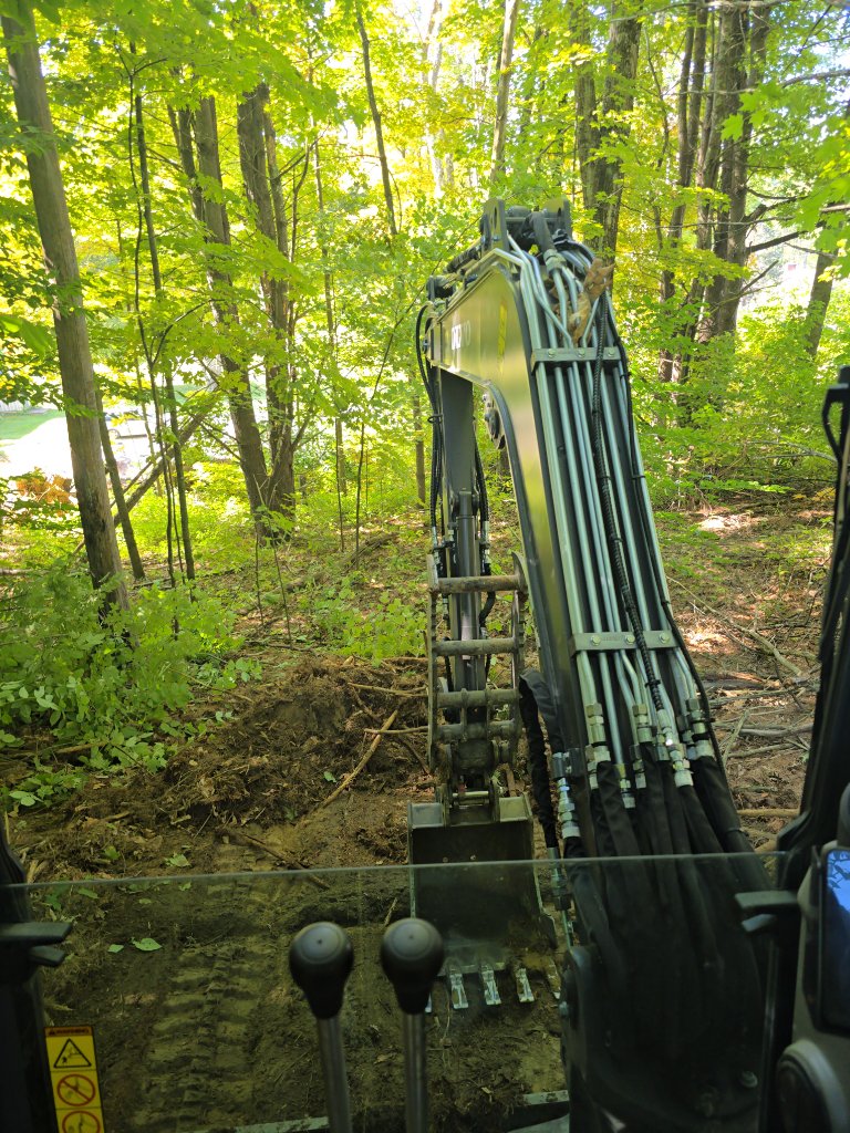 Dark Horse Construction excavator trenching for an underground electrical service in Vermont