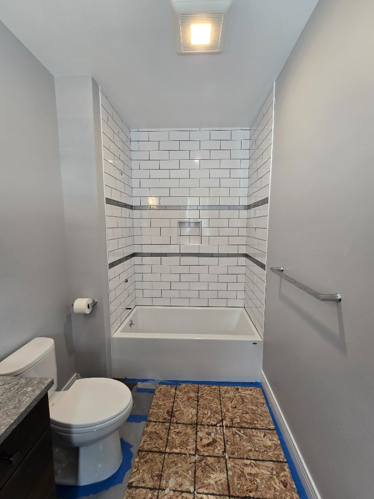 Bathroom renovation with new tile surround completed by Dark Horse Construction in Vermont