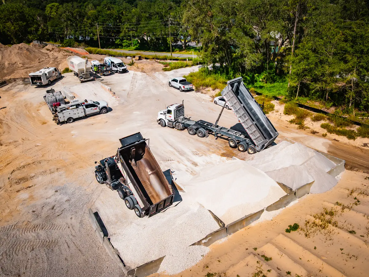 Aerial view of a dump truck unloading in the yard