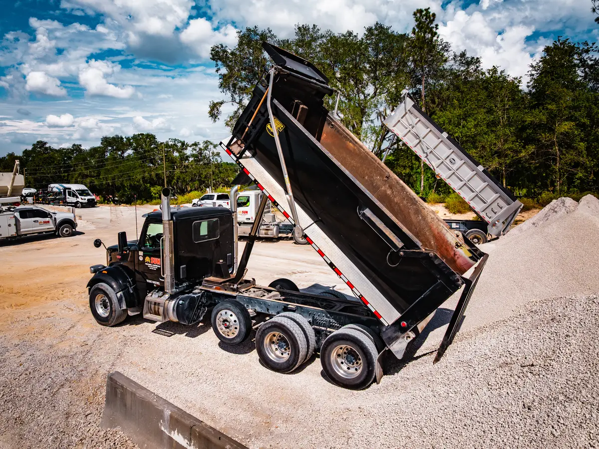 Dump trucks offloading rock at the materials yard