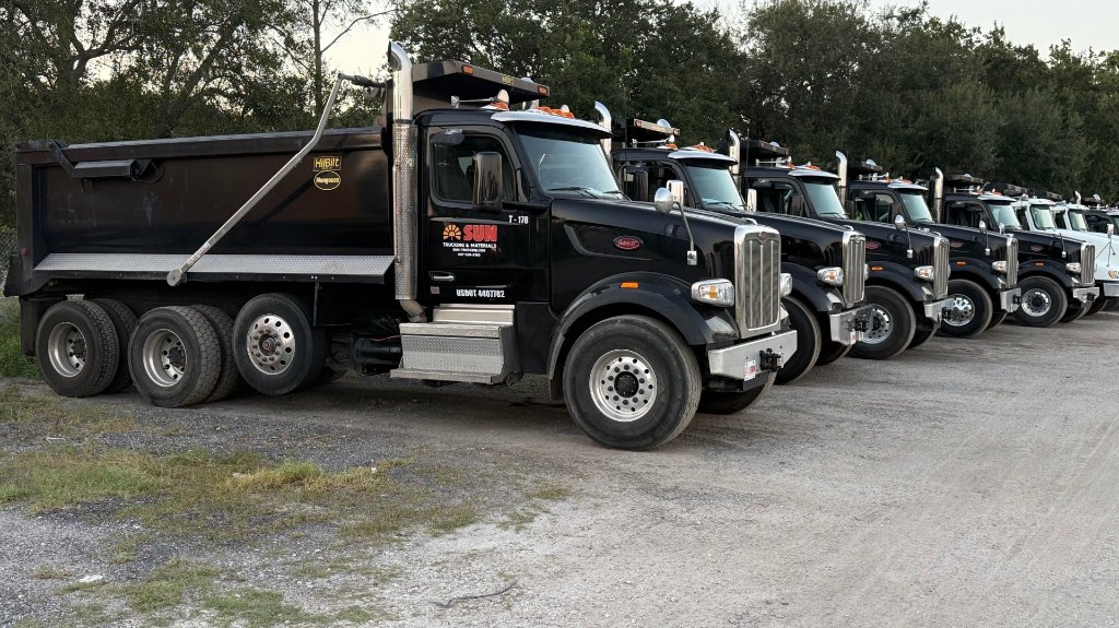 Sun Trucking mini-wheeler dump truck delivering fill dirt at a Central Florida job site