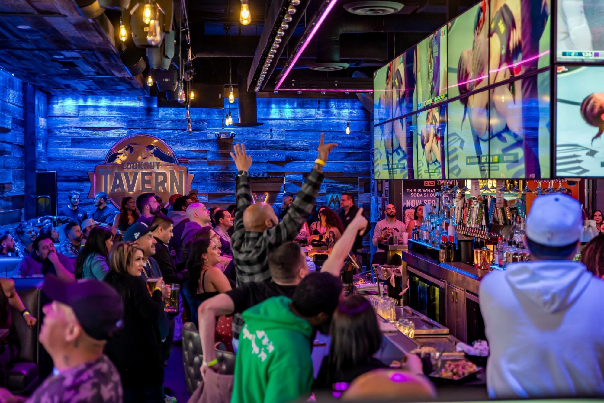 A fight night crowd cheering at the LED walls