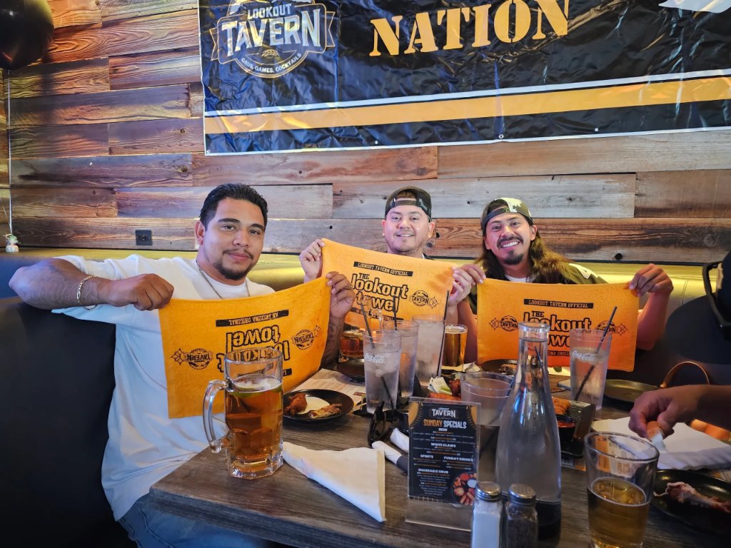 Steelers fans holding Lookout towels under the NATION banner at Lookout Tavern