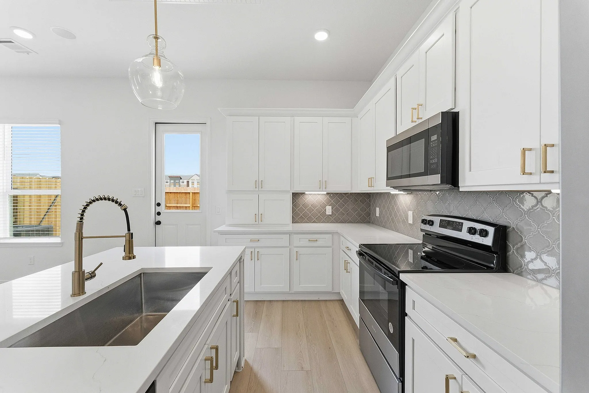 Modern kitchen with white cabinets and gold fixtures