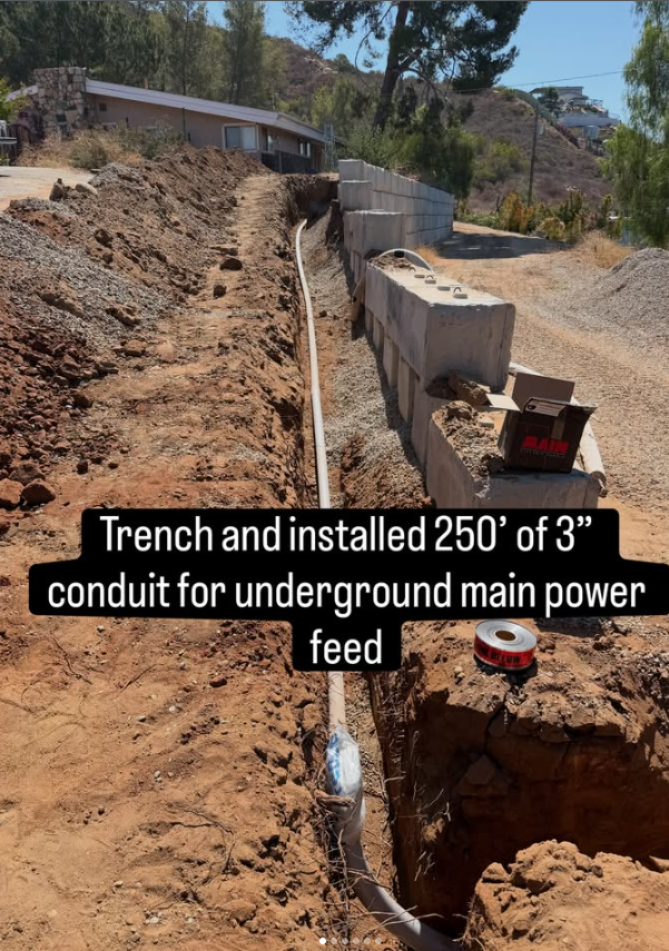 Underground trenching and 3-inch conduit installation alongside a retaining wall in Eucalyptus Hills, CA
