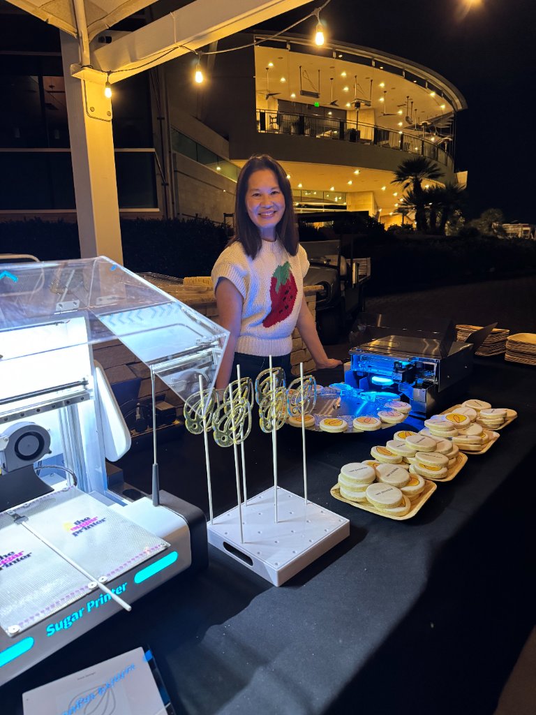 Sweet Printer operator with sugar lollipops and cookies at night event