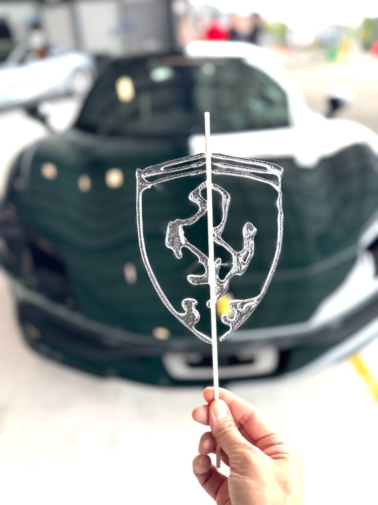 Ferrari logo lollipop over luxury Ferrari