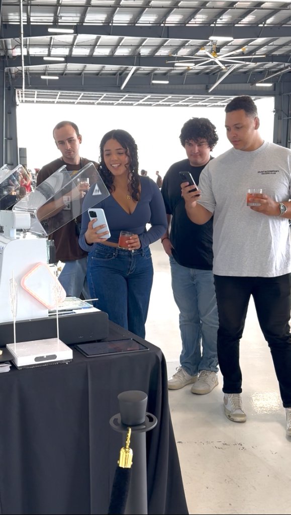 Crowd watching sugar lollipop get printed live