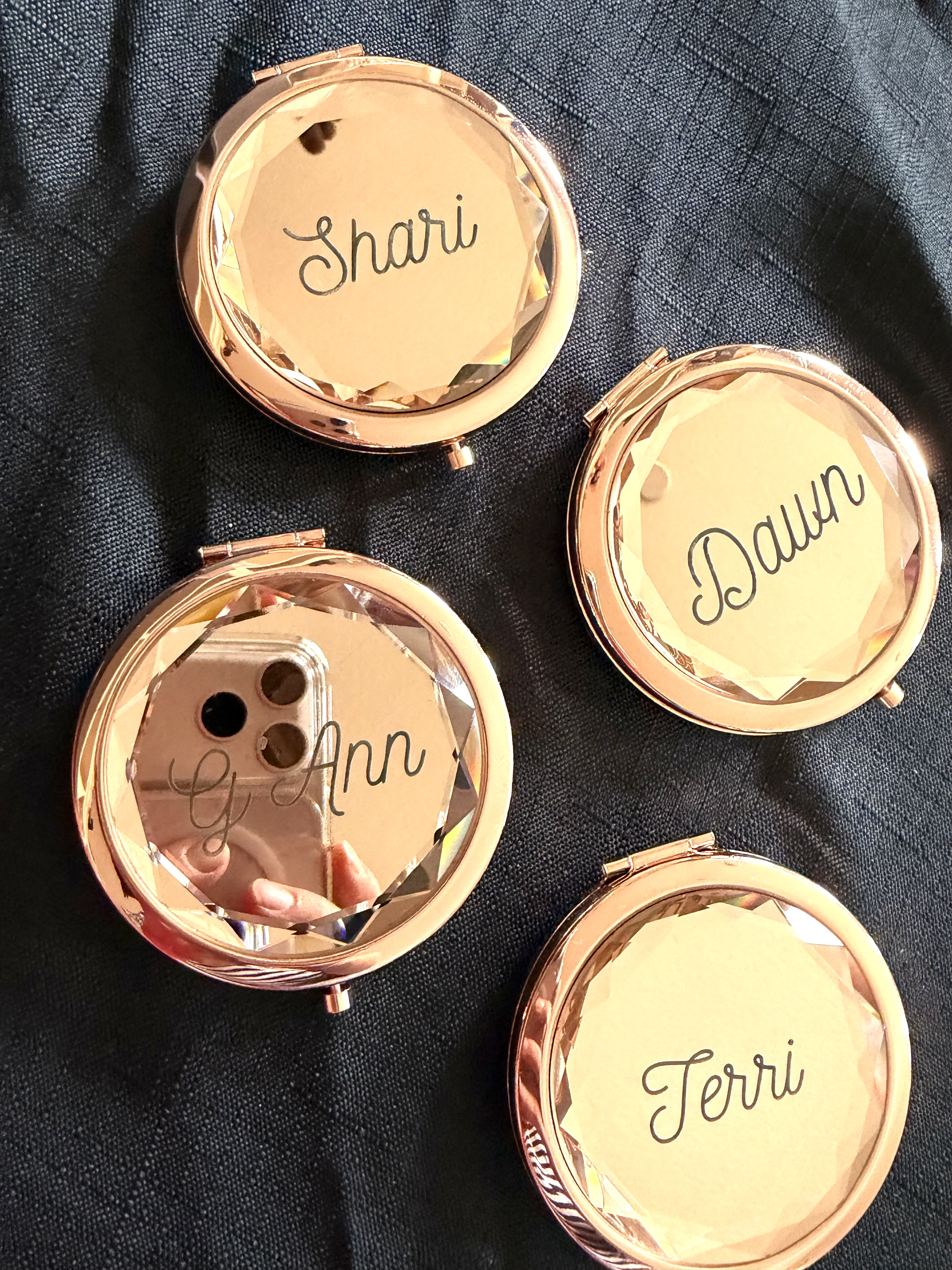 Rose gold compact mirrors laser engraved with names Shari, Dawn, Terri, and G'Ann
