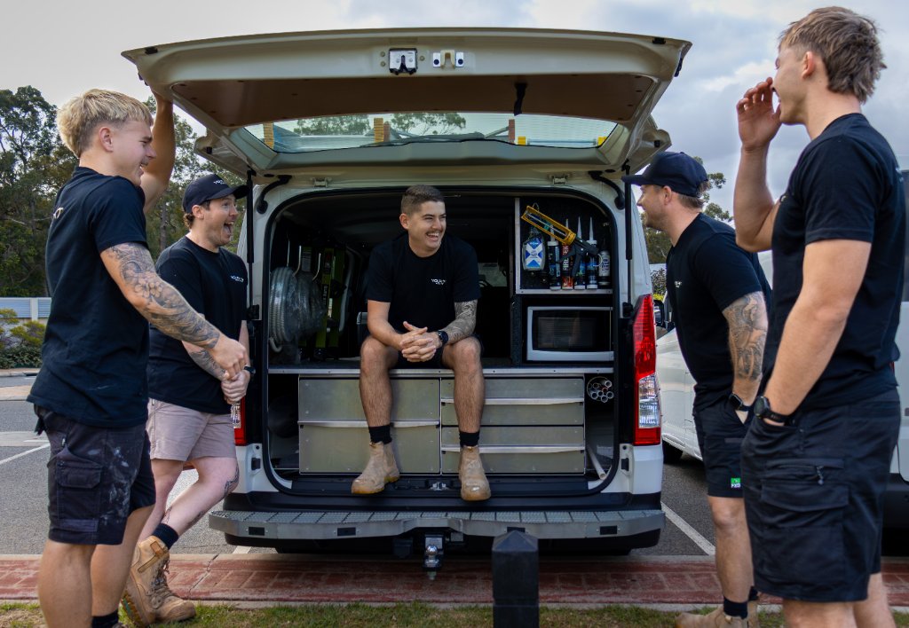 YourNext Electrician team laughing at the back of the van