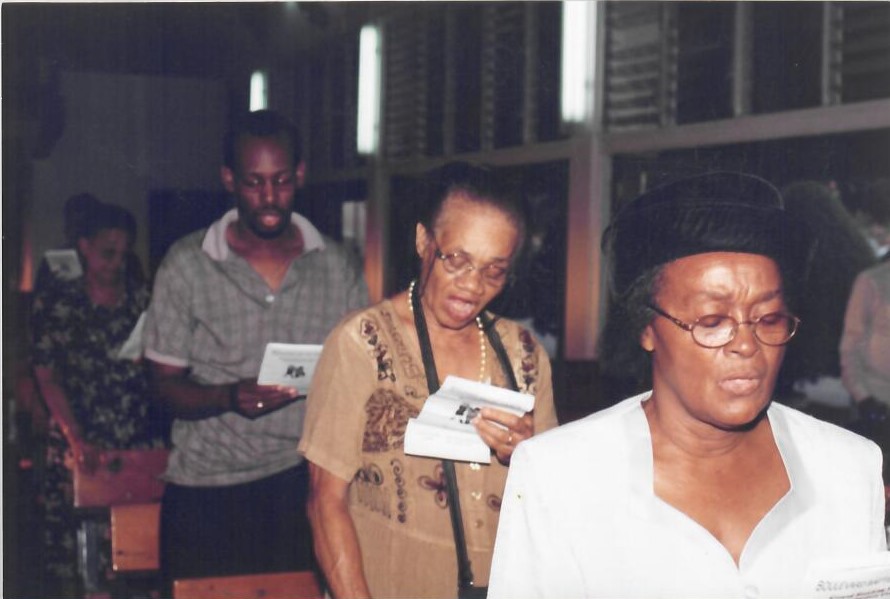 Church members reading from their programs