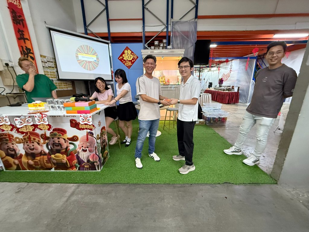 Leadership presenting red packets to the team