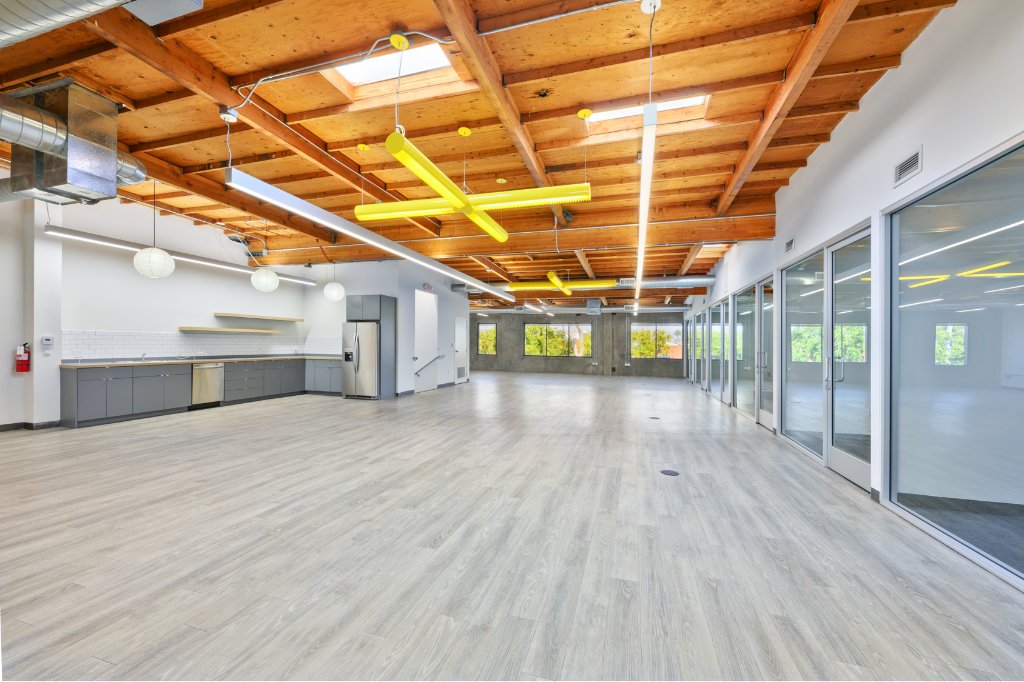 Suite 2027 with warm hardwood floors and glass-fronted offices
