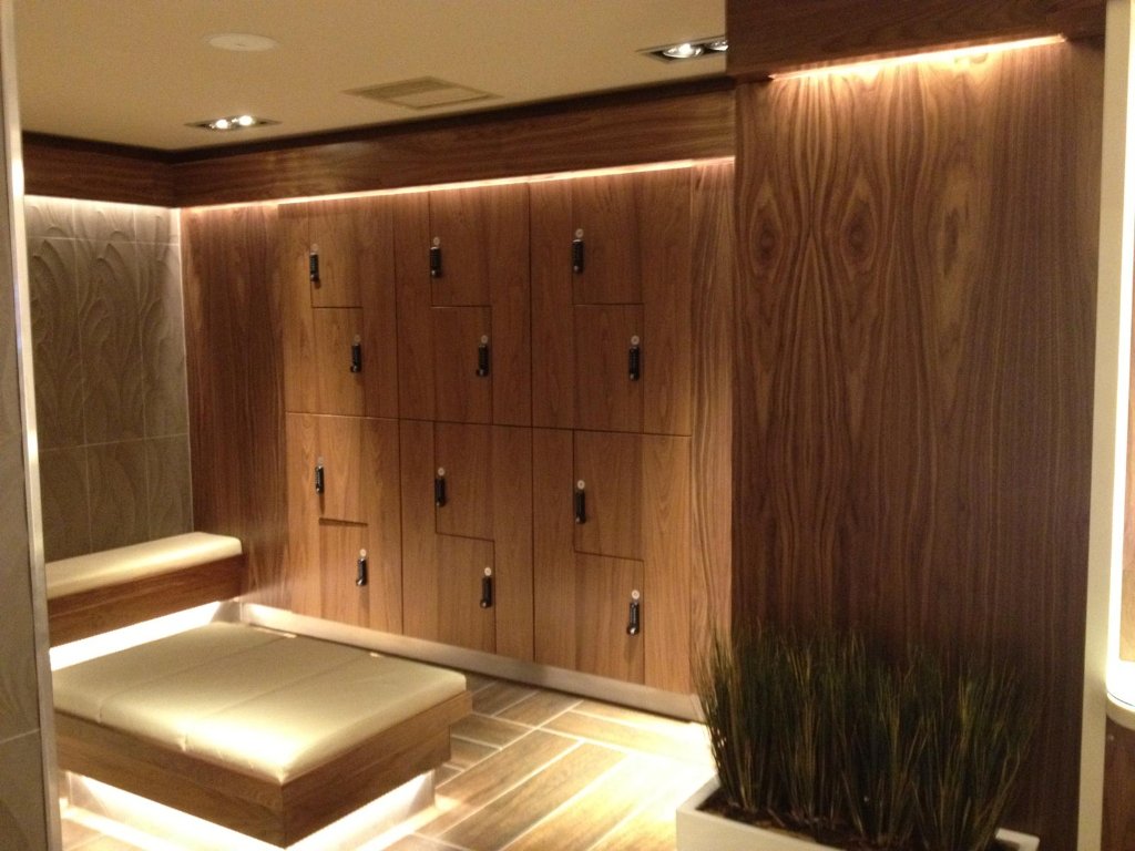 Bespoke walnut locker room with integrated lighting by HEFF