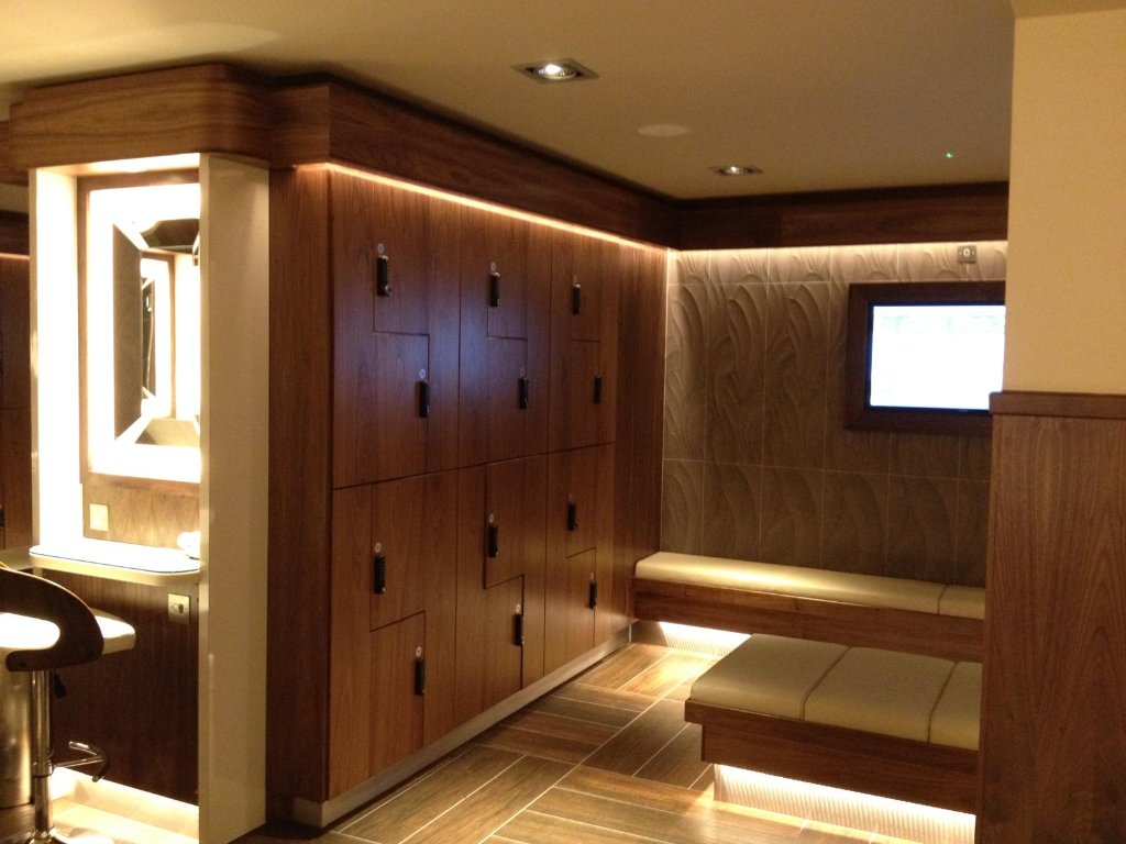 Walnut changing room with lockers and seating by HEFF