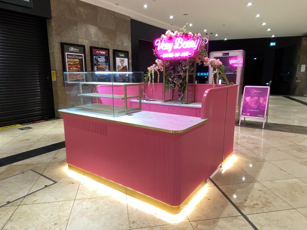 Bespoke pink retail kiosk with neon signage by HEFF