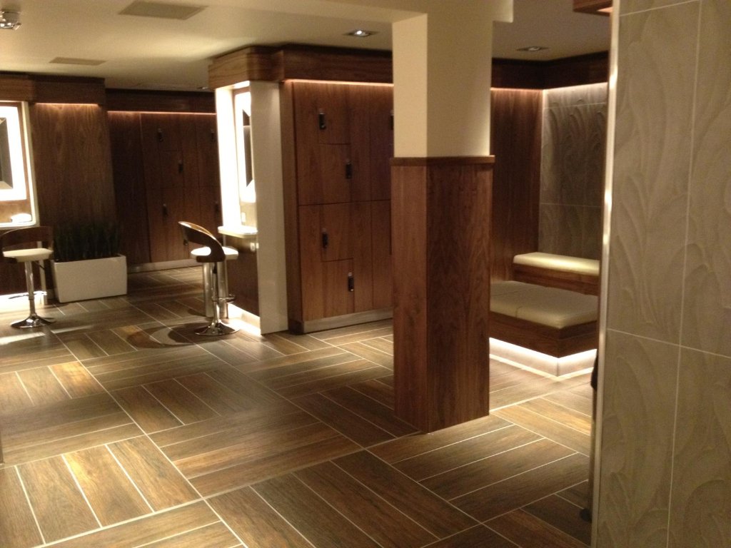 Commercial walnut fitted furniture with integrated lighting by HEFF