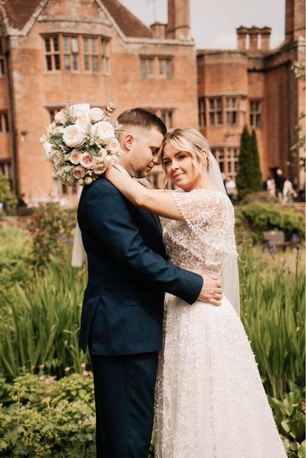 Bride and groom in manor garden