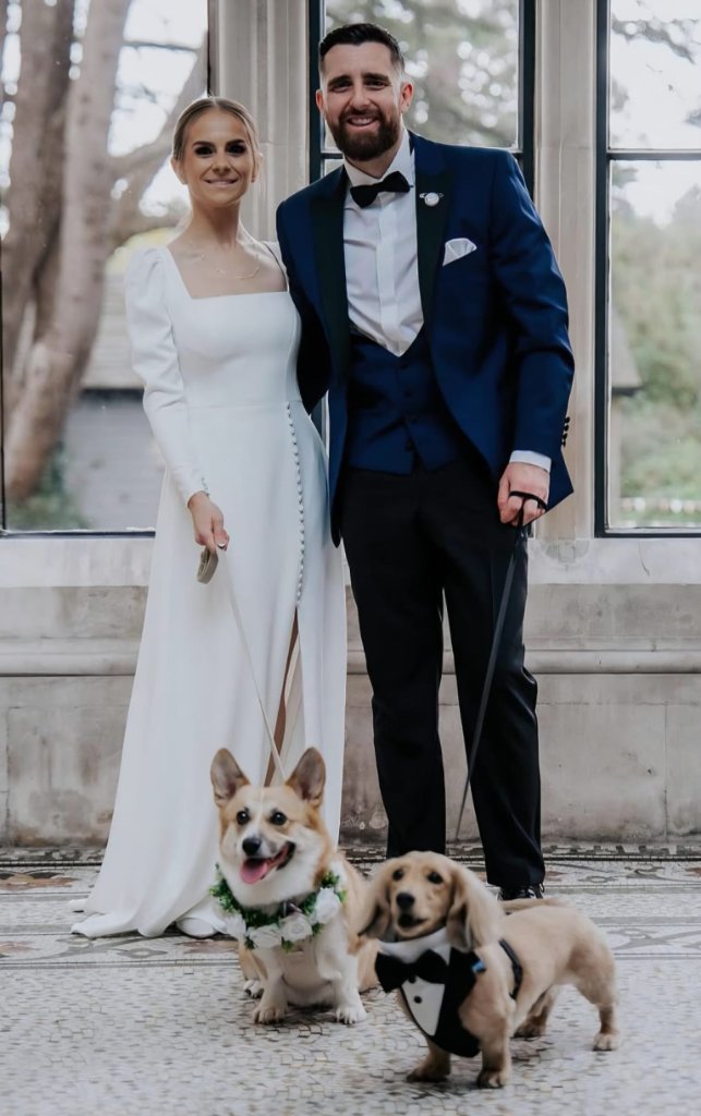 Bride and groom with their dogs on their wedding day