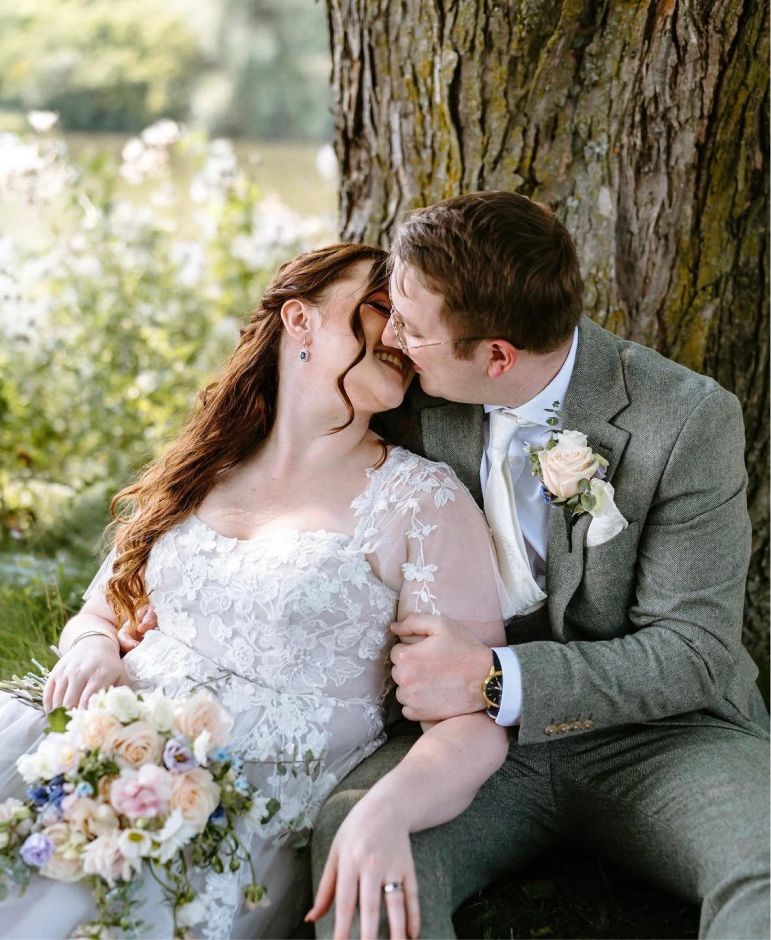 Bride and groom by a tree
