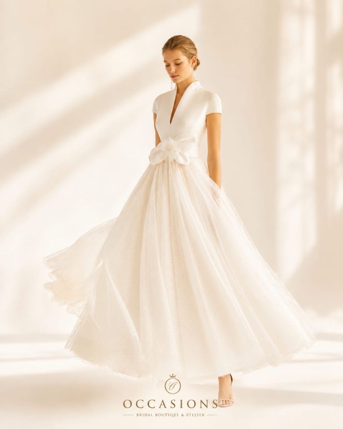 Bride in an A-line gown with a sculptural bow at the waist in the studio