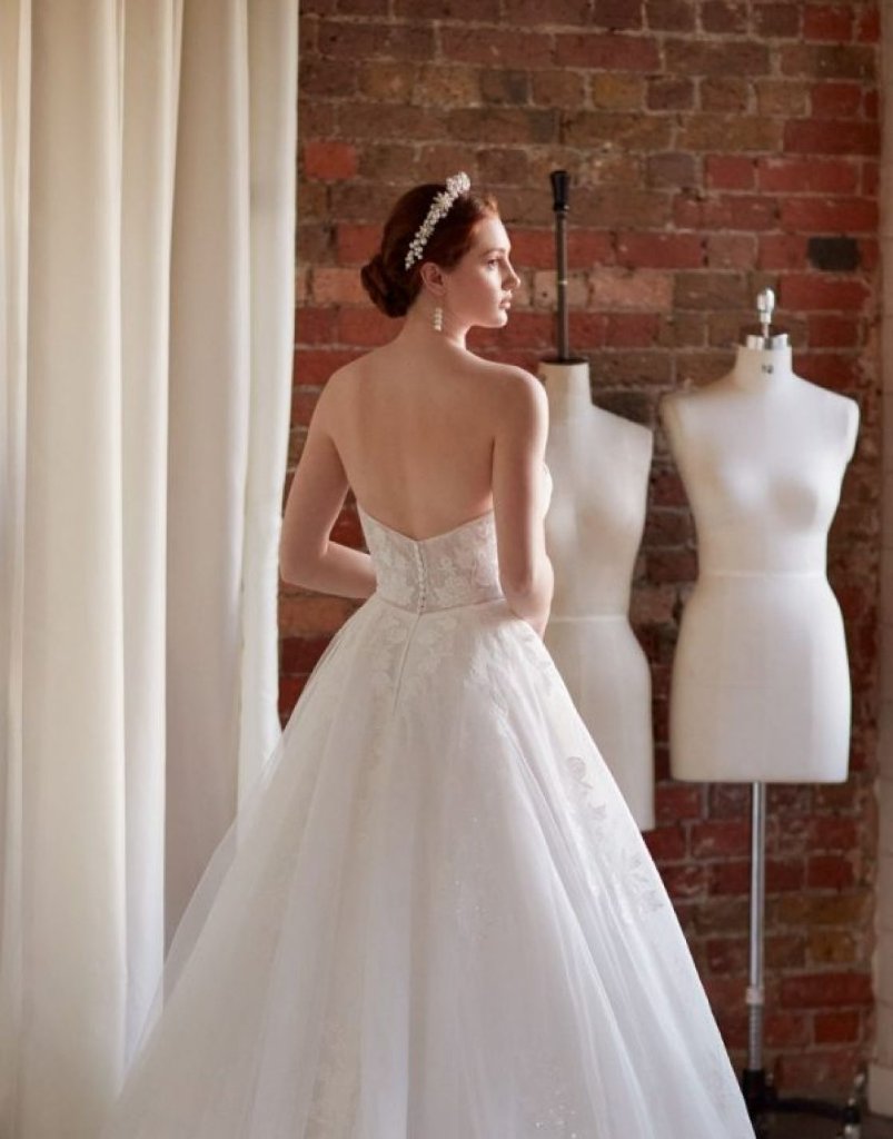 Bride in bridal gown with dressmaker mannequin