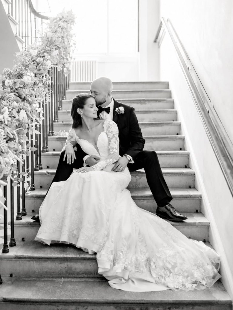 Black and white portrait of a bride and groom on a staircase