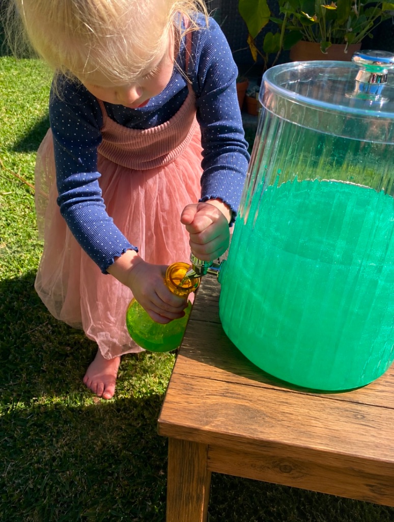 Child playing with a water dispenser