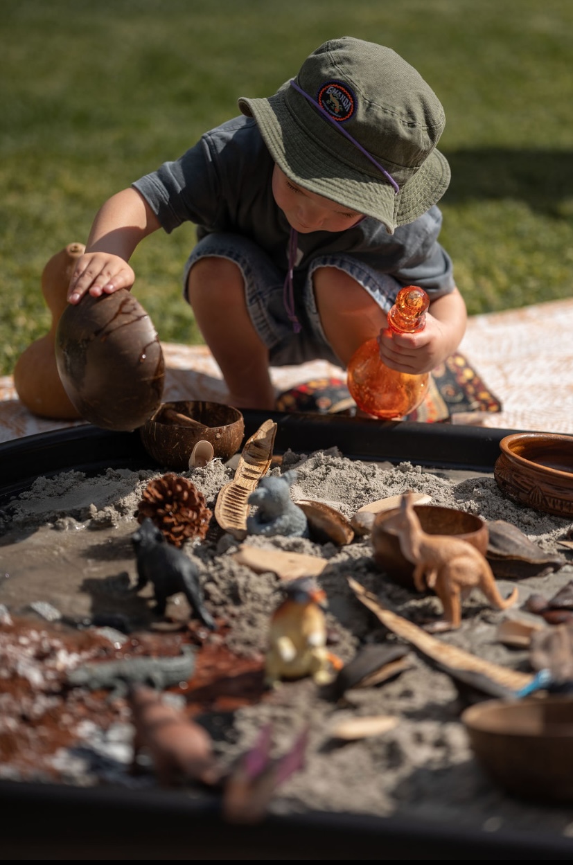 Little hands exploring a sensory tray