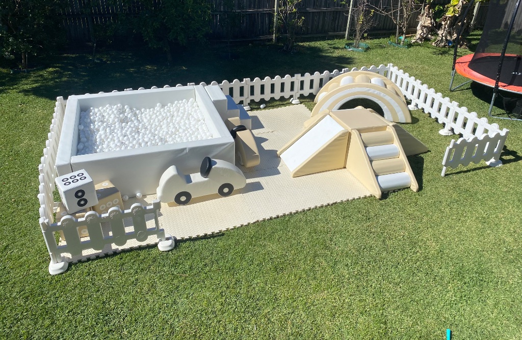 Full soft play setup with ball pit, slide, and ride-on cars