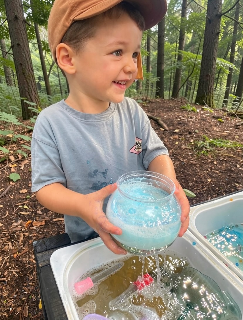 Little hands exploring a sensory tray