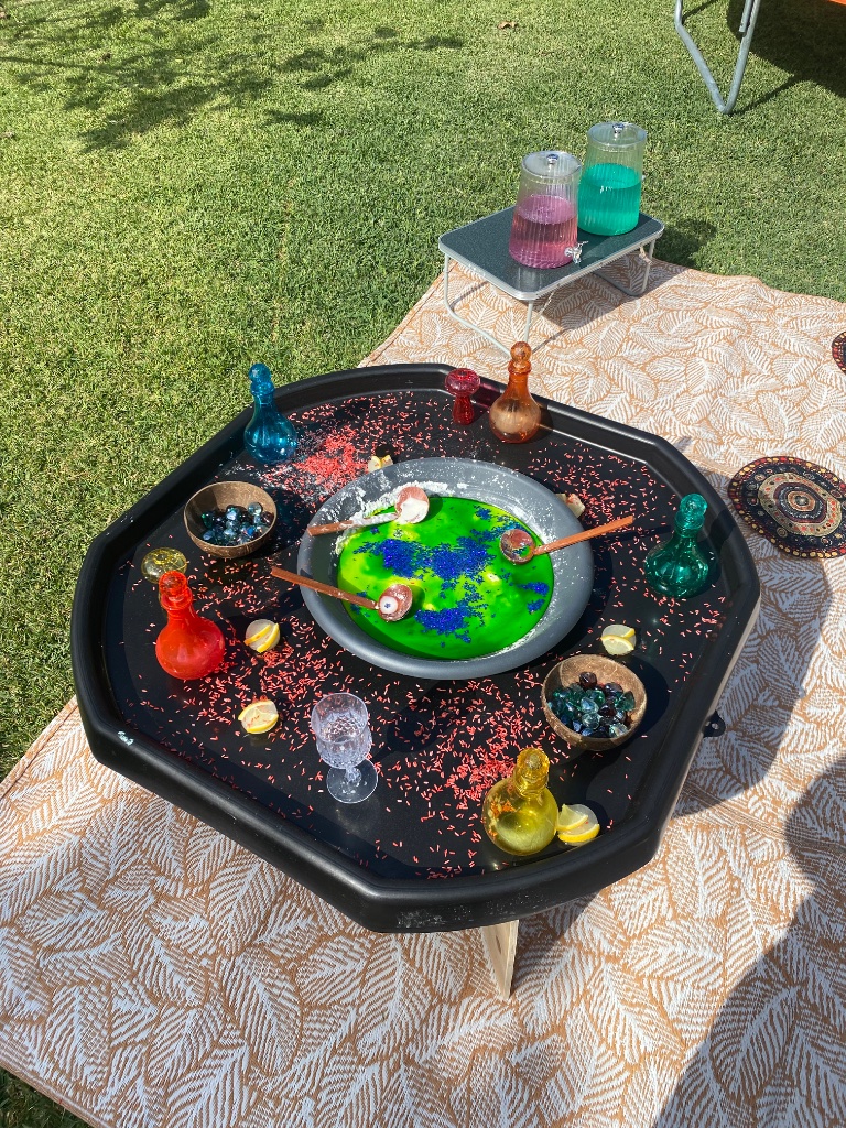 Potion-making sensory tray with colourful bottles