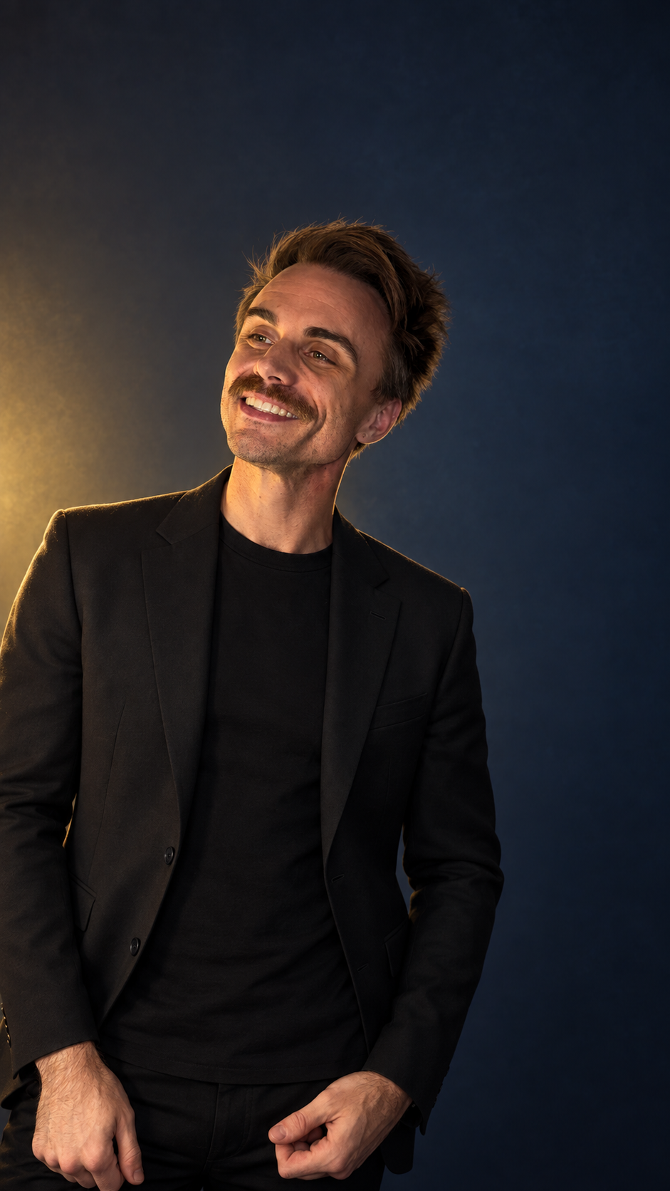 Gannon Waye, smiling in gold light