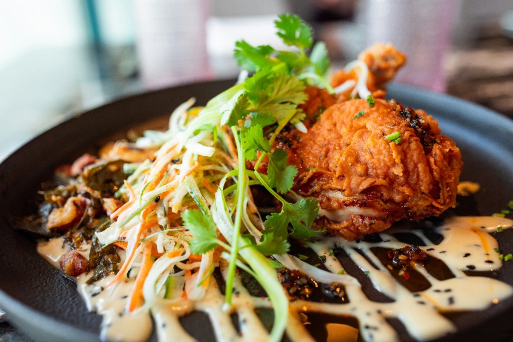 Plated fried chicken with slaw and herbs prepared by Kahelia Spencer of Key’s Catering