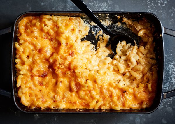 A baked pan of macaroni and cheese with a golden crust.