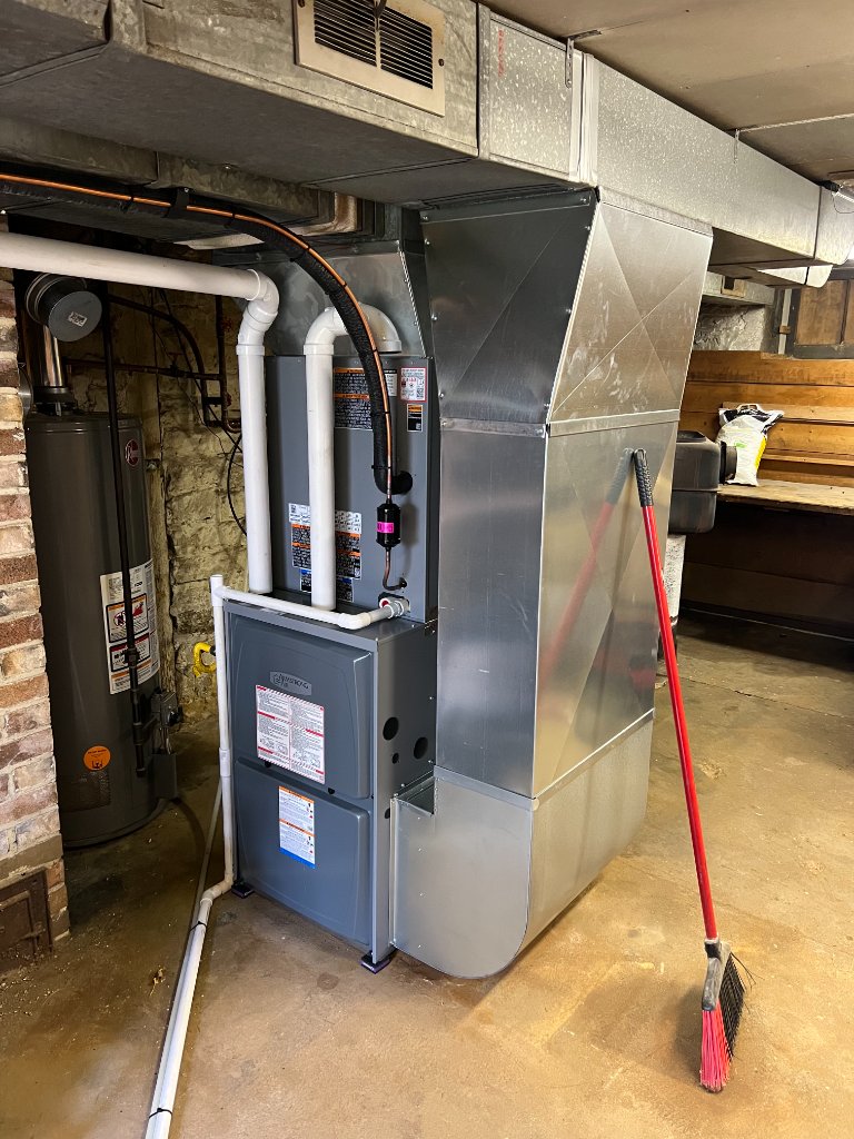 A further view of a furnace installation, emphasizing the piping and ductwork necessary for ventilation and airflow.