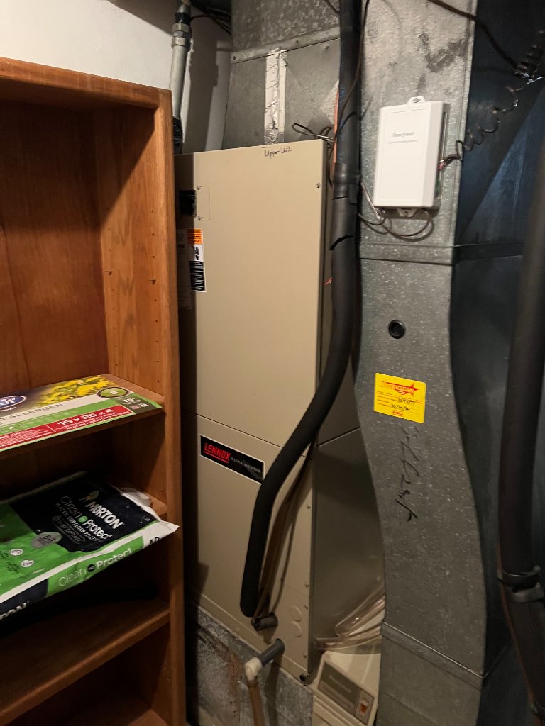 An image showing a furnace installation, complete with ductwork and system controls, typical of residential heating setups.