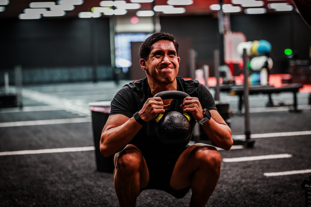 Athlete in a deep kettlebell squat