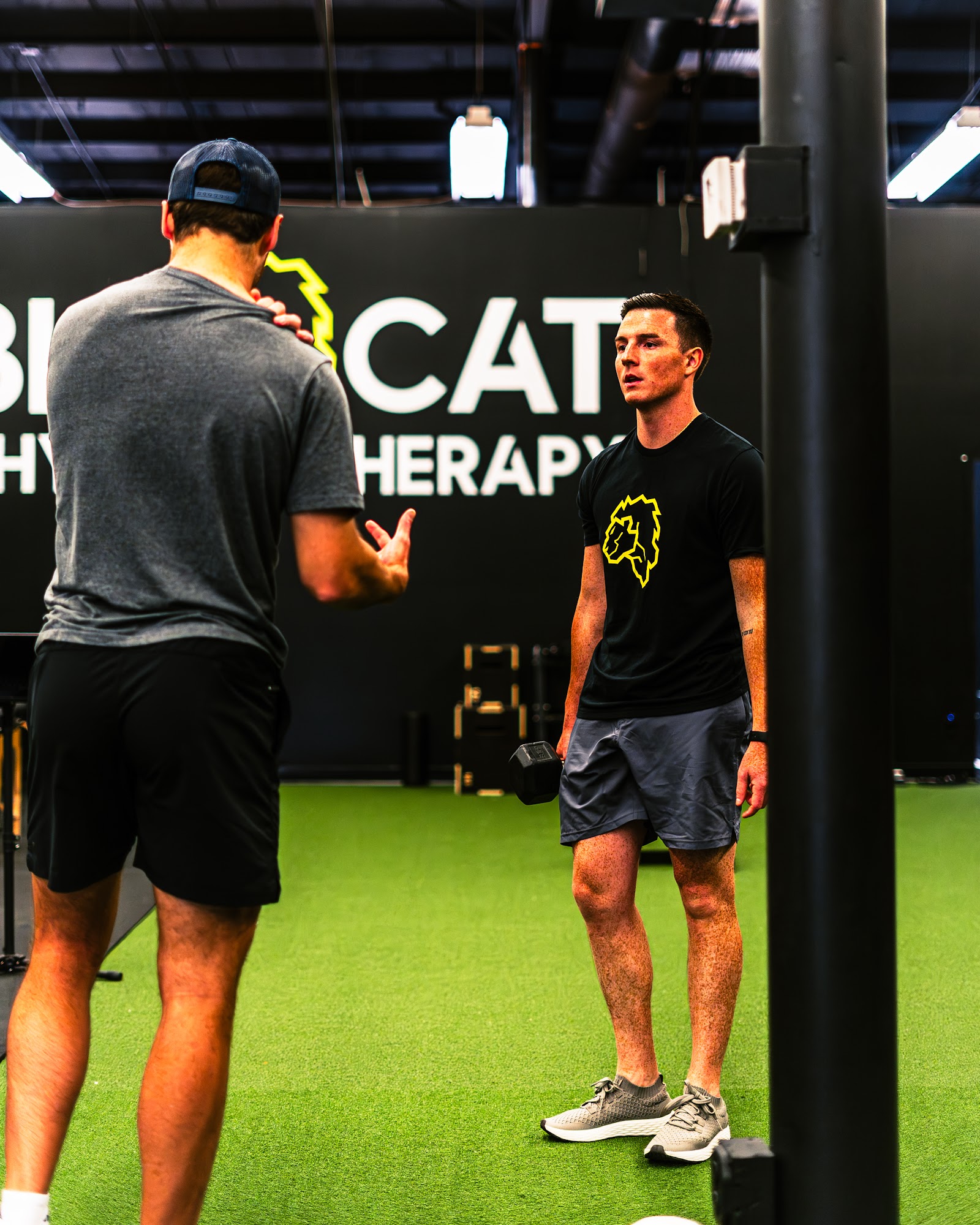 Physical therapist coaching on the turf