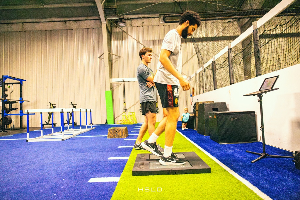 blue and green turf training area with agility hurdles and a plyo box at Big Cat Twinsburg
