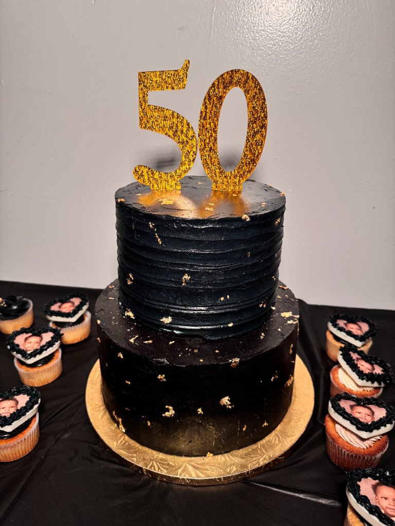 Two-tier black and gold 50th birthday cake