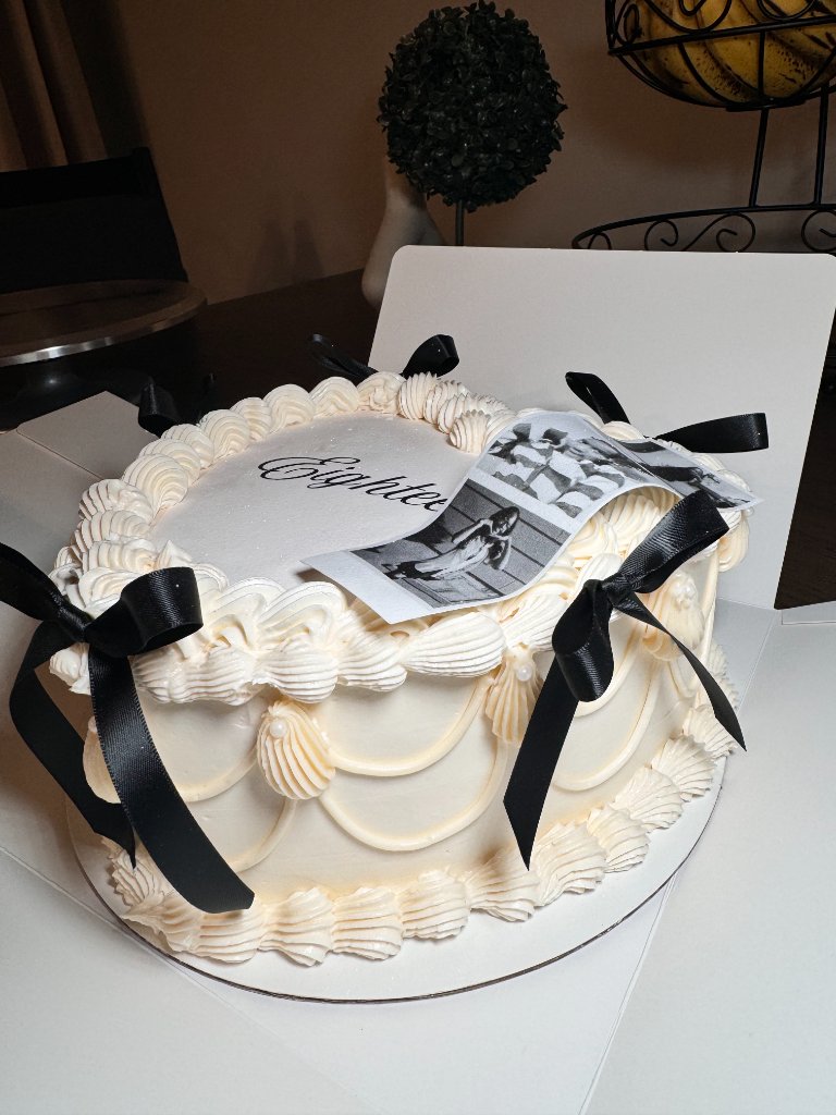 Elegant white cake with black bows