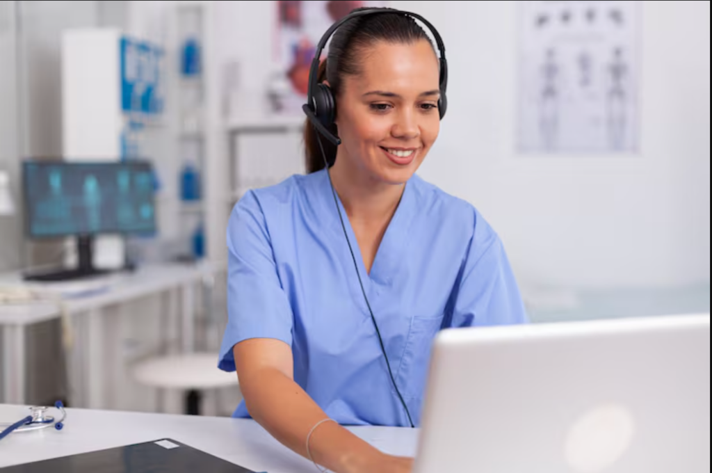 Healthcare professional with headset at computer