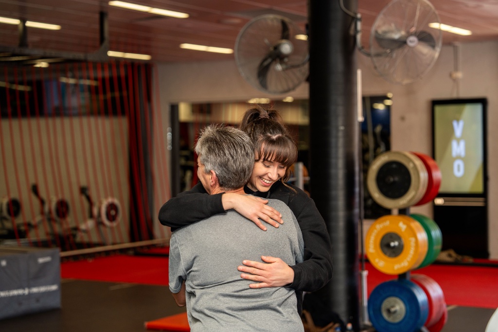 Sara embracing a client after a session — the moment that matters