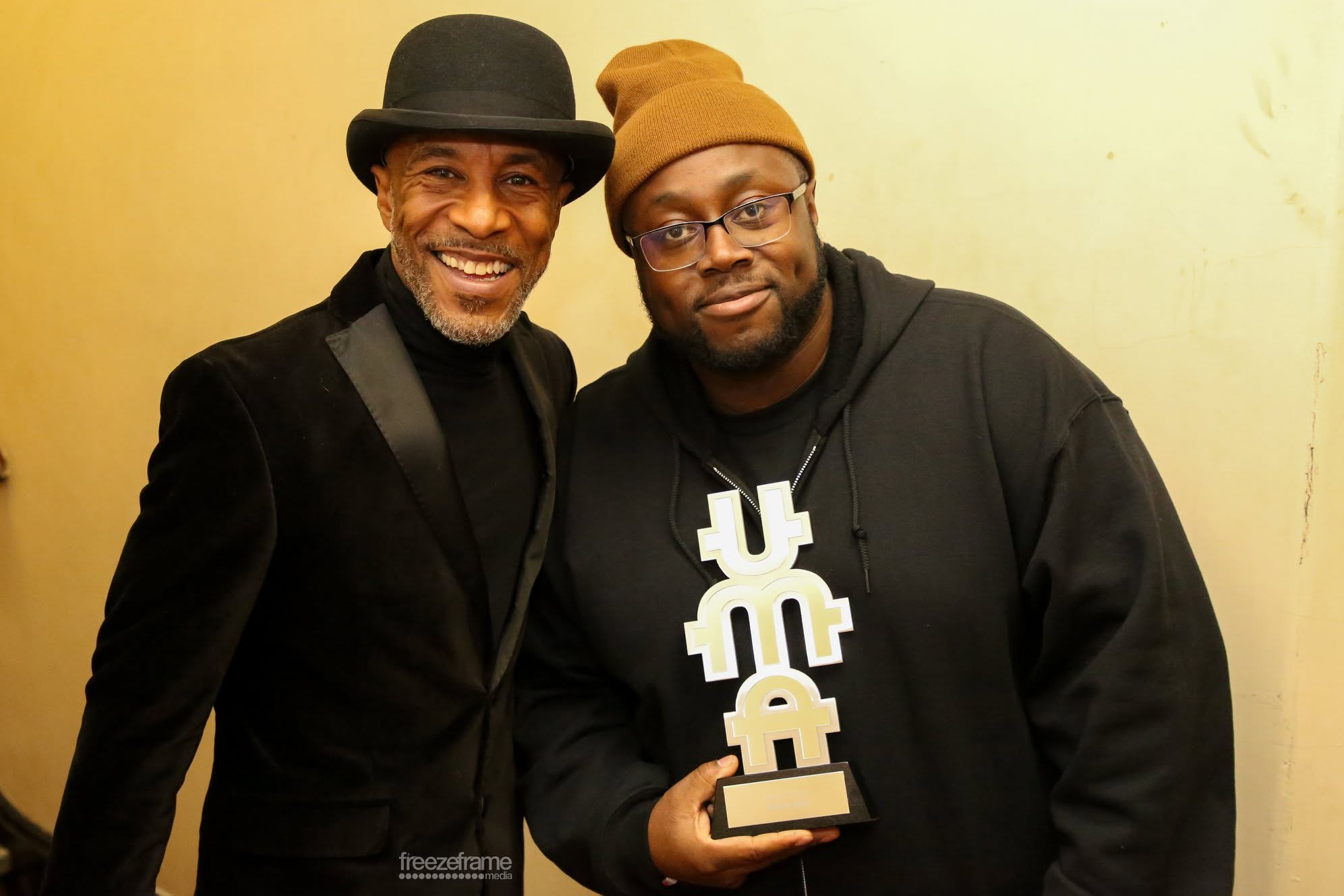 UMA winners posing with the Urban Music Awards trophy