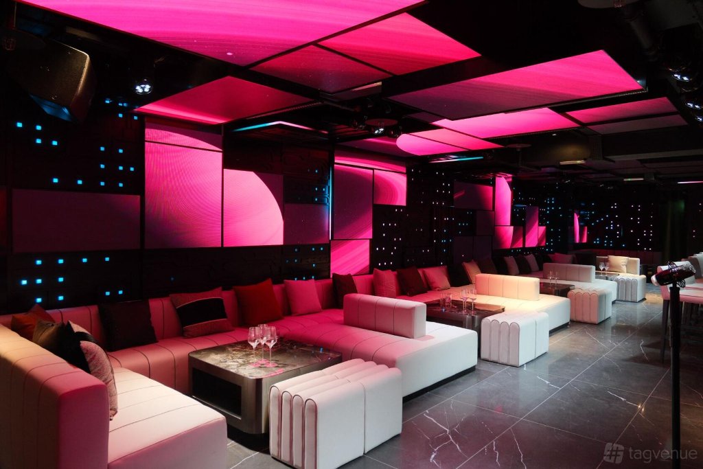 U9 London lounge with pink neon lighting and marble flooring