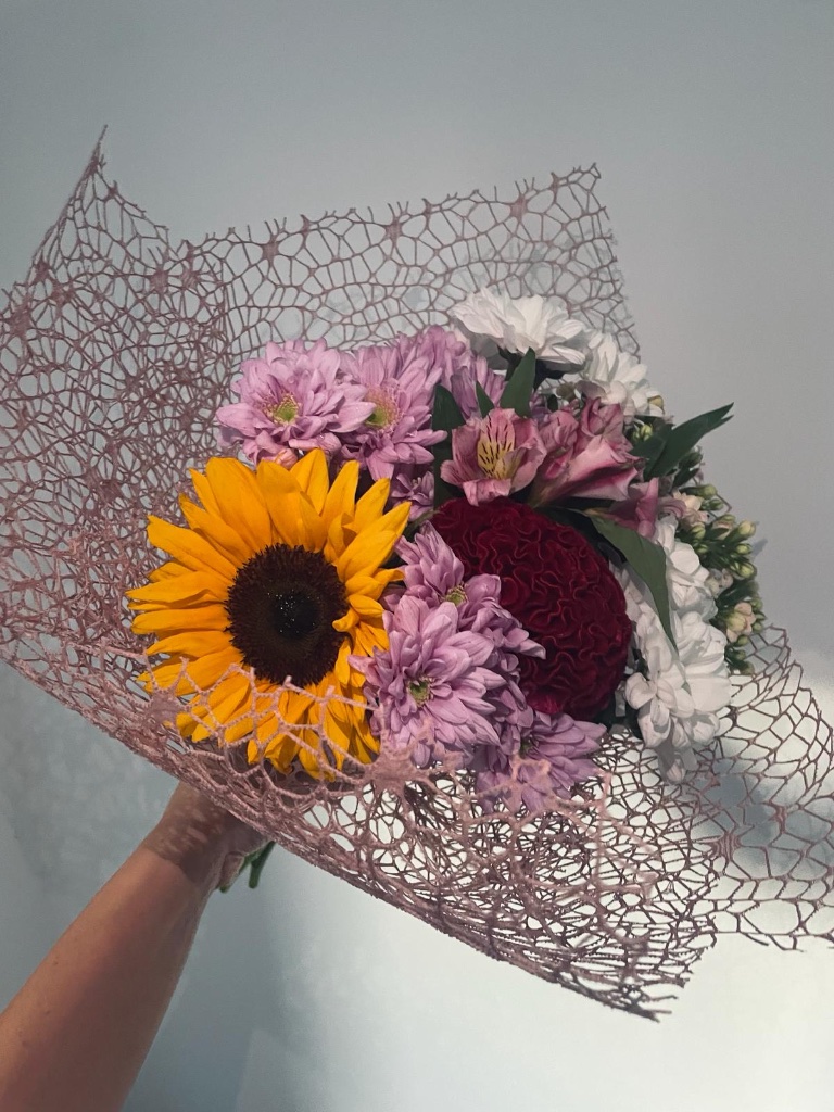 Sunflower and mixed blooms bouquet in mesh wrap by Kalea Arrangements